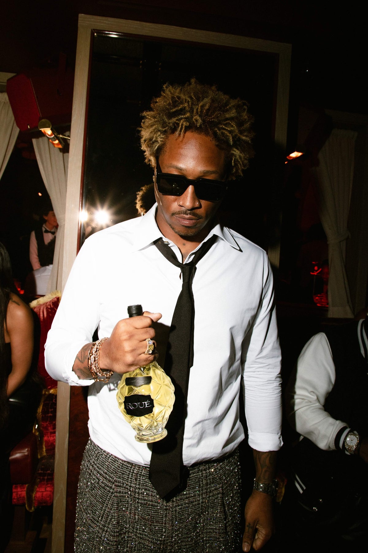 Future holding a bottle of Roue Sauvignon Blanc